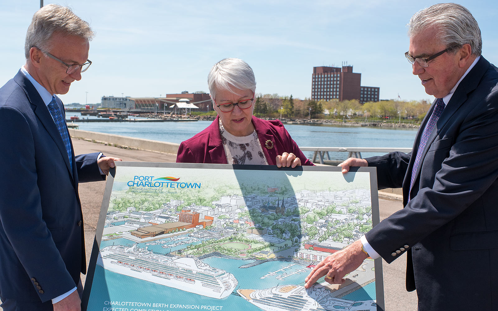 Sean Casey, Paula Biggar and Stan MacPherson look over the artist rendition of the newly expanded Port of Charlottetown