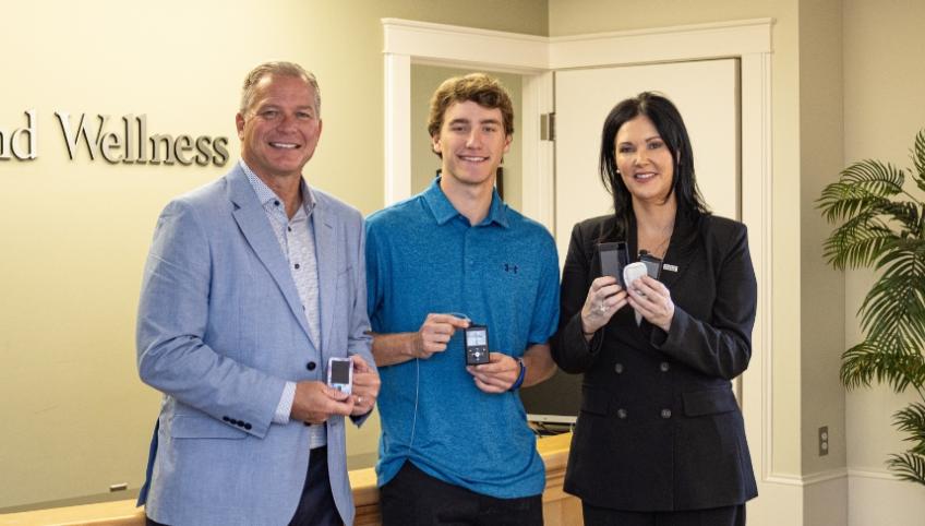 Image of 3 pople holding insulin pump