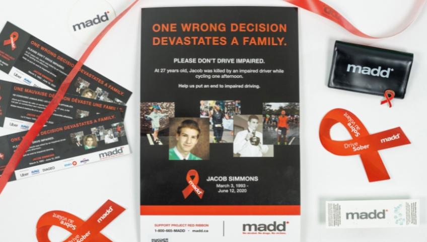 image of a poster with red ribbon and brochures on both side of it 