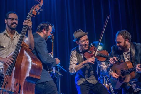 Image of band playing on stage Image of band playing