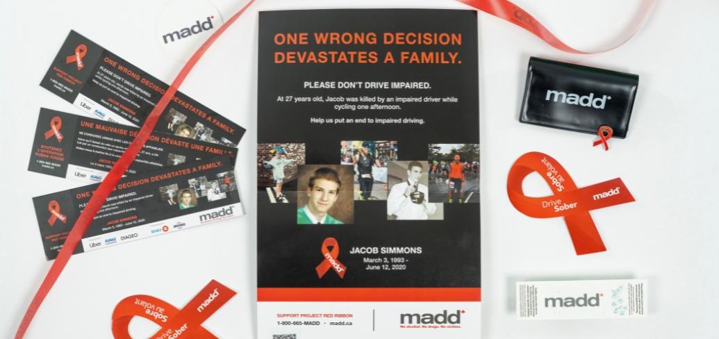 image of a poster with red ribbon and brochures on both side of it 