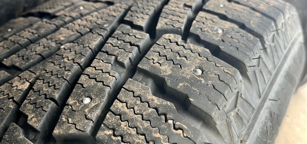 image of tire with metals studs in it