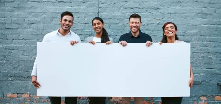 people holding a blank  sign