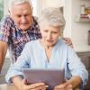 Elderly couple looking at a tablet.