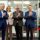 image of four people clapping their hands after a ribbon cutting ceremony