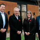 image of four people standing in front of a building