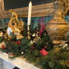 image of christmas decorations and greenery on a fireplace mantle