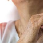 photo of an elderly woman's hand holding a younger person's hand